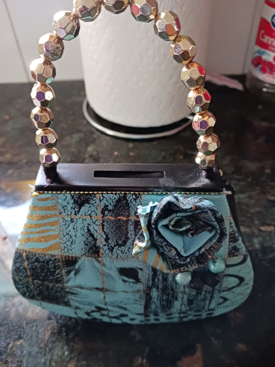 This is a coin bank Decorative Clutch Purse with Beaded Handle