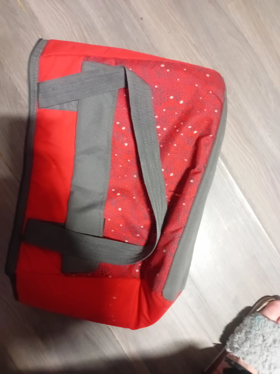 Red duffel bag with white speckles