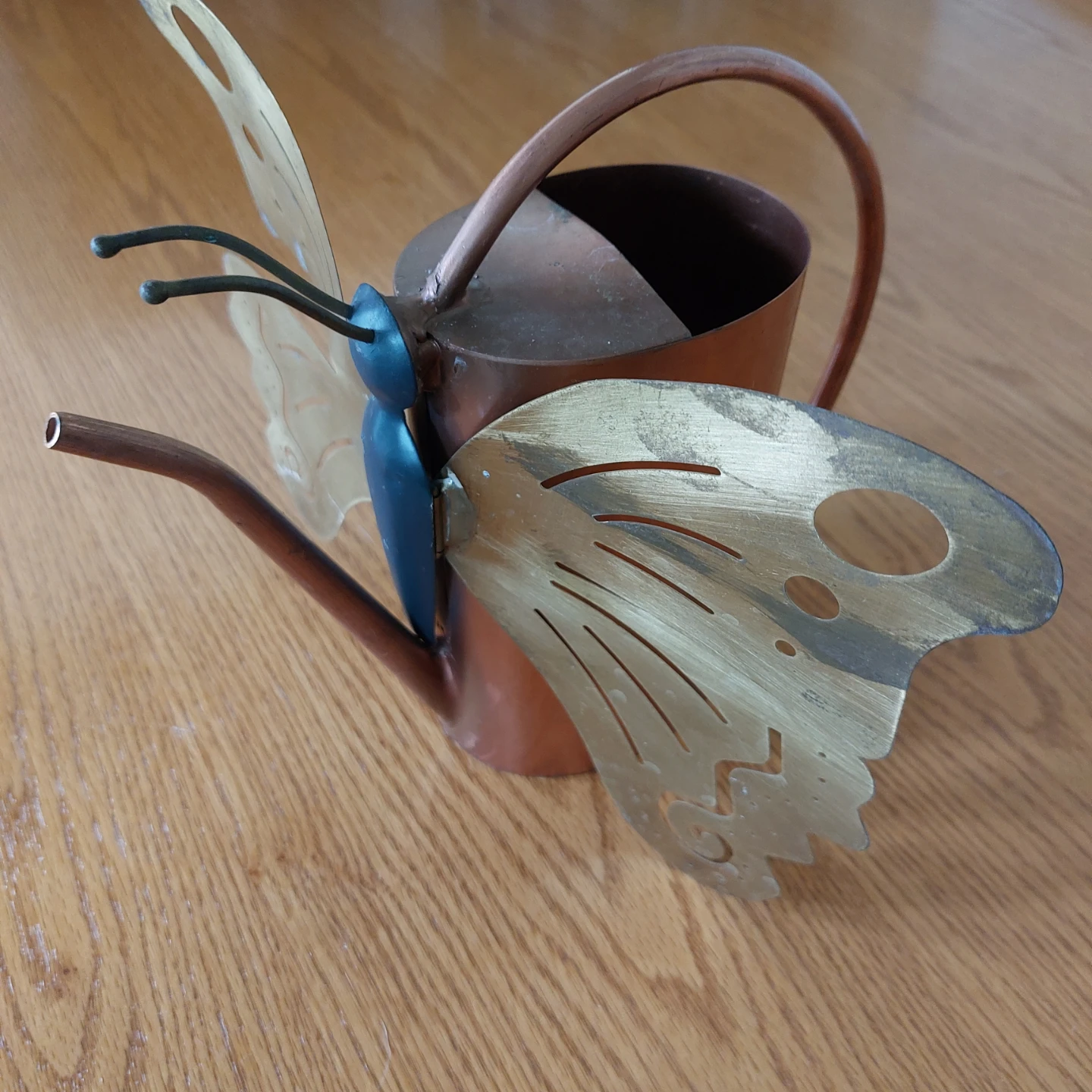 Coppe and brass decorative watering can.