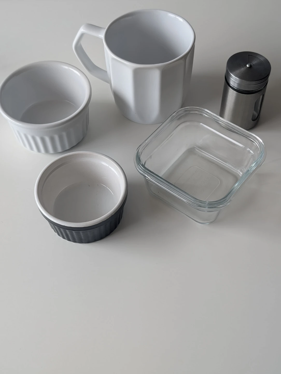 Kitchenwares including ramekins, mug, glass cont., and shaker