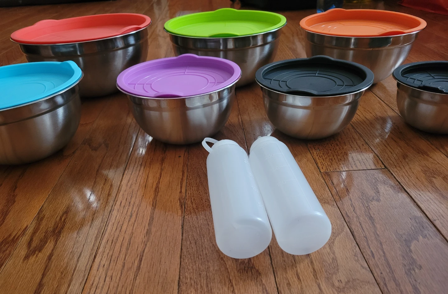 7 SS Bowls with Lids + 2 plastic bottles for oil. New!
