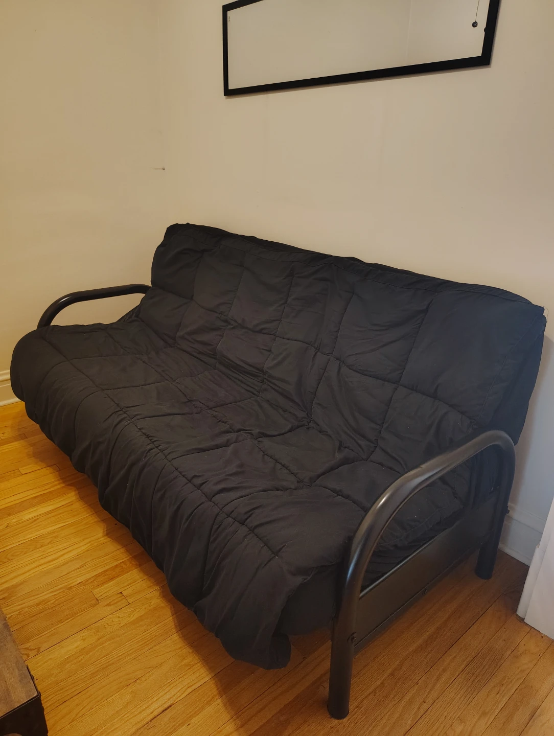 Black futon couch with metal frame