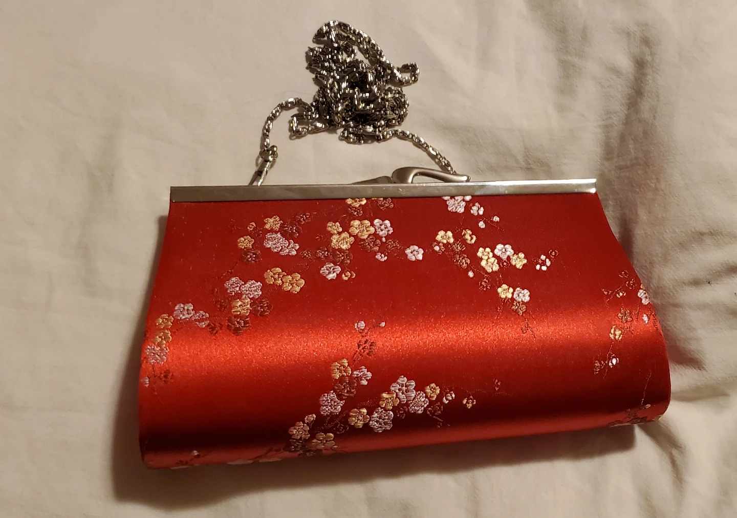 Red clutch with floral embroidery