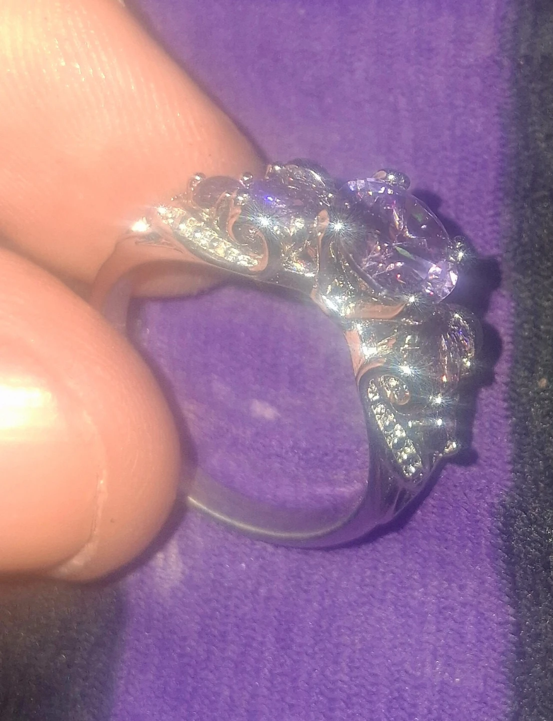 Silver tone ring with purple and clear stones