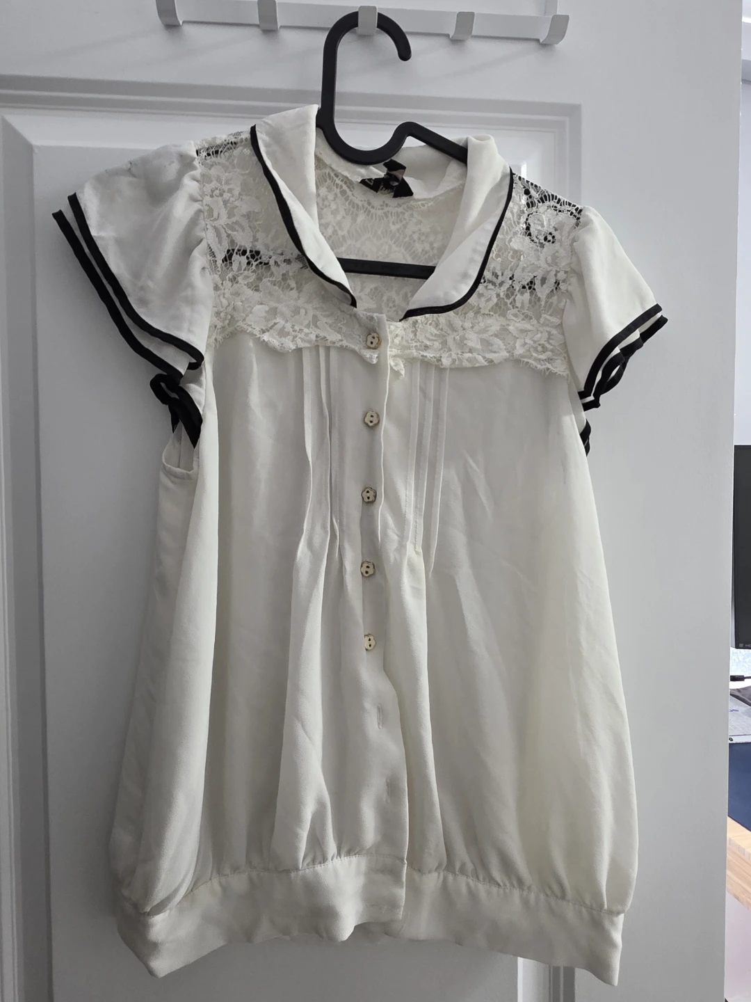 White blouse with black seams and lace