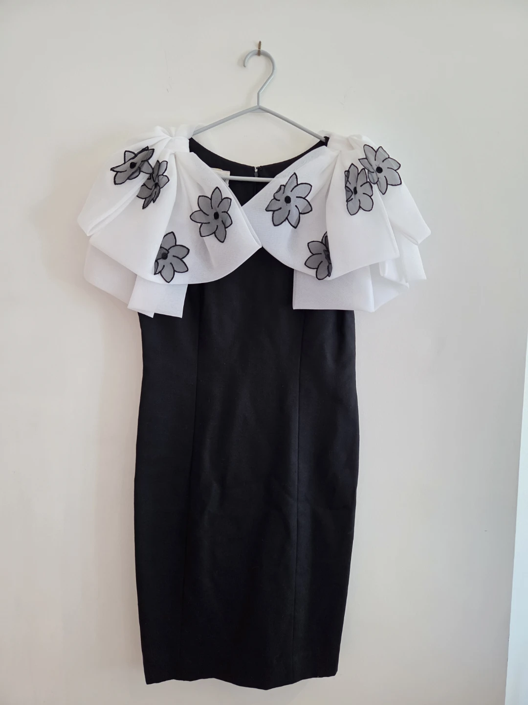 Black sheath dress with white floral overlay collar