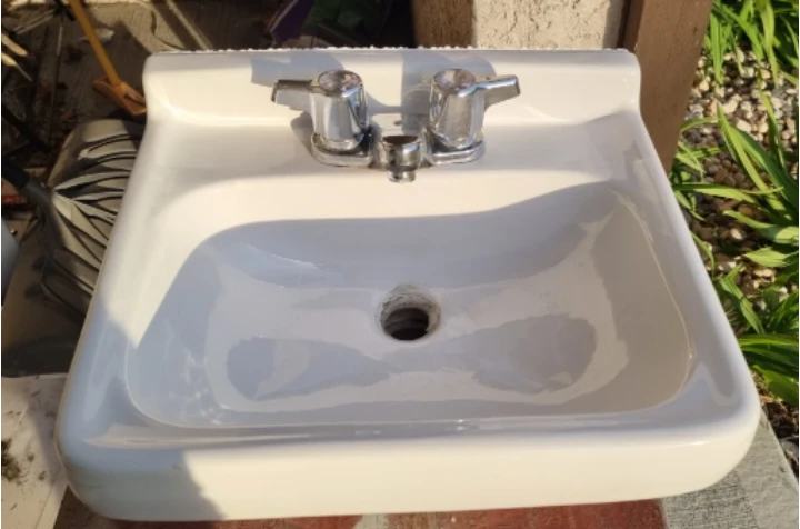 White Wall-Mounted Sink with Chrome Faucets