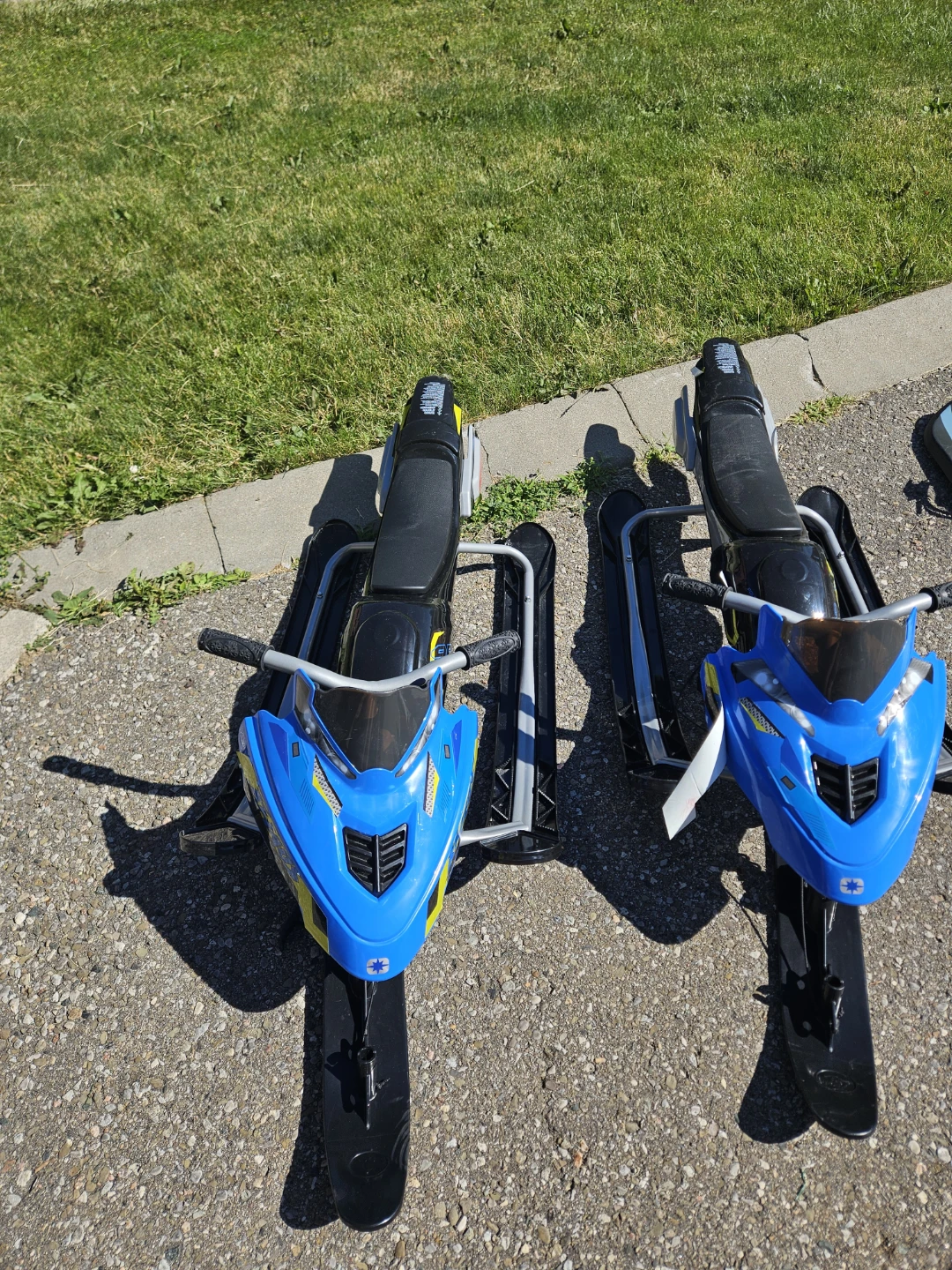 Pair of Blue and Yellow Kids Snowmobiles
