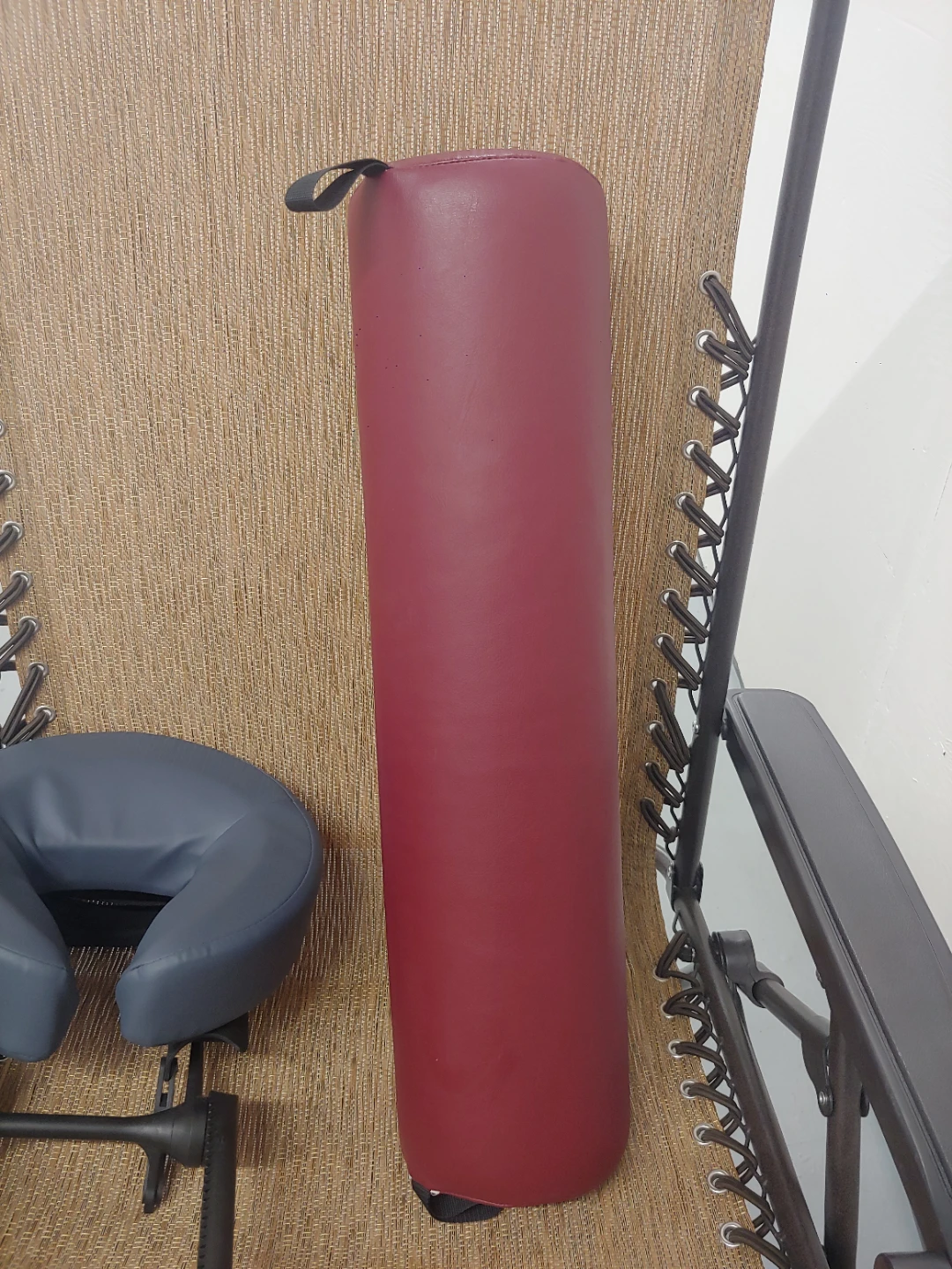Maroon bolster cushion for massage therapist or acupuncture