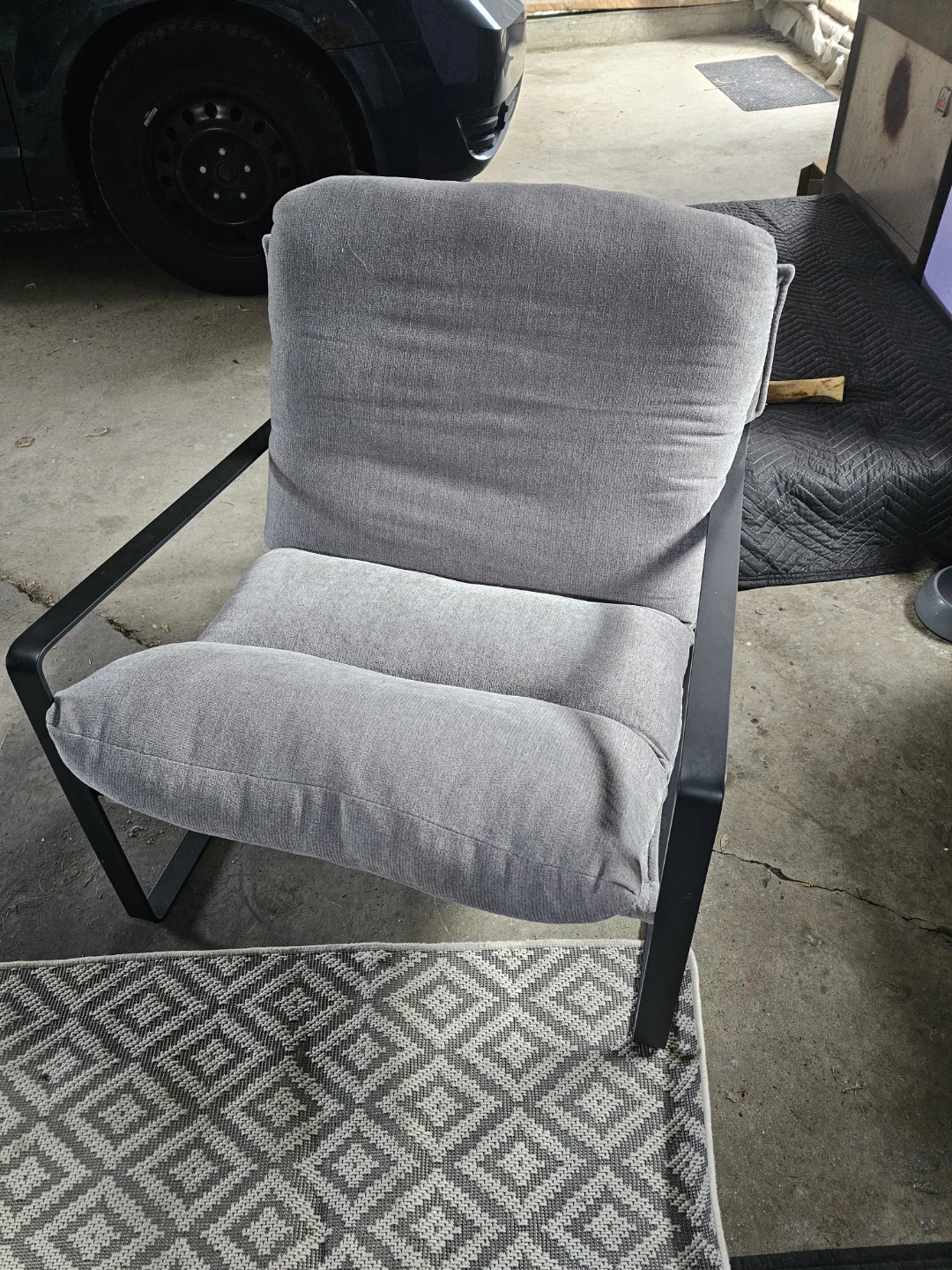 Grey accent chair with black metal frame