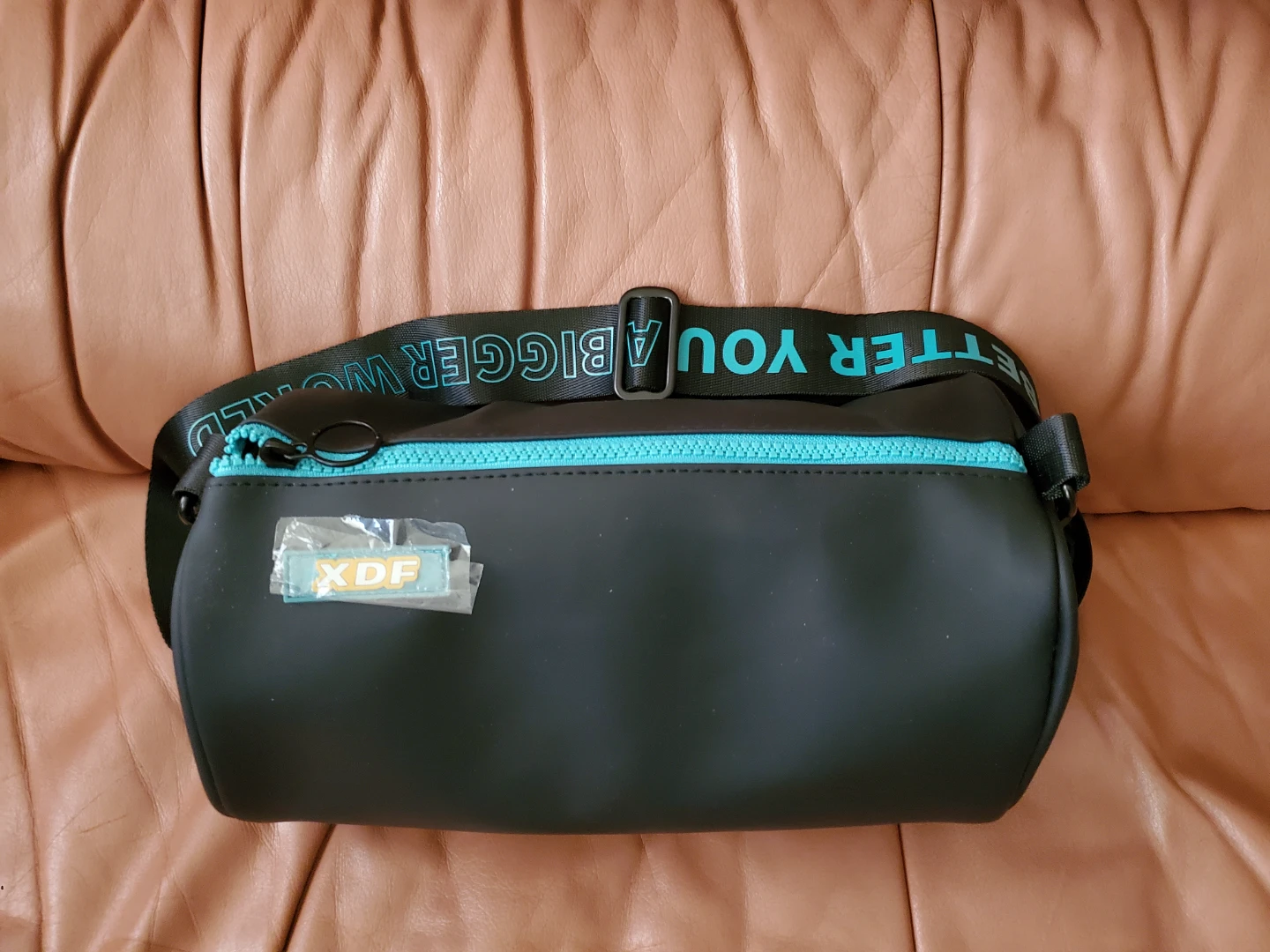 Black barrel bag with blue zipper and "A BETTER YOU A BIGGER" - photo 3