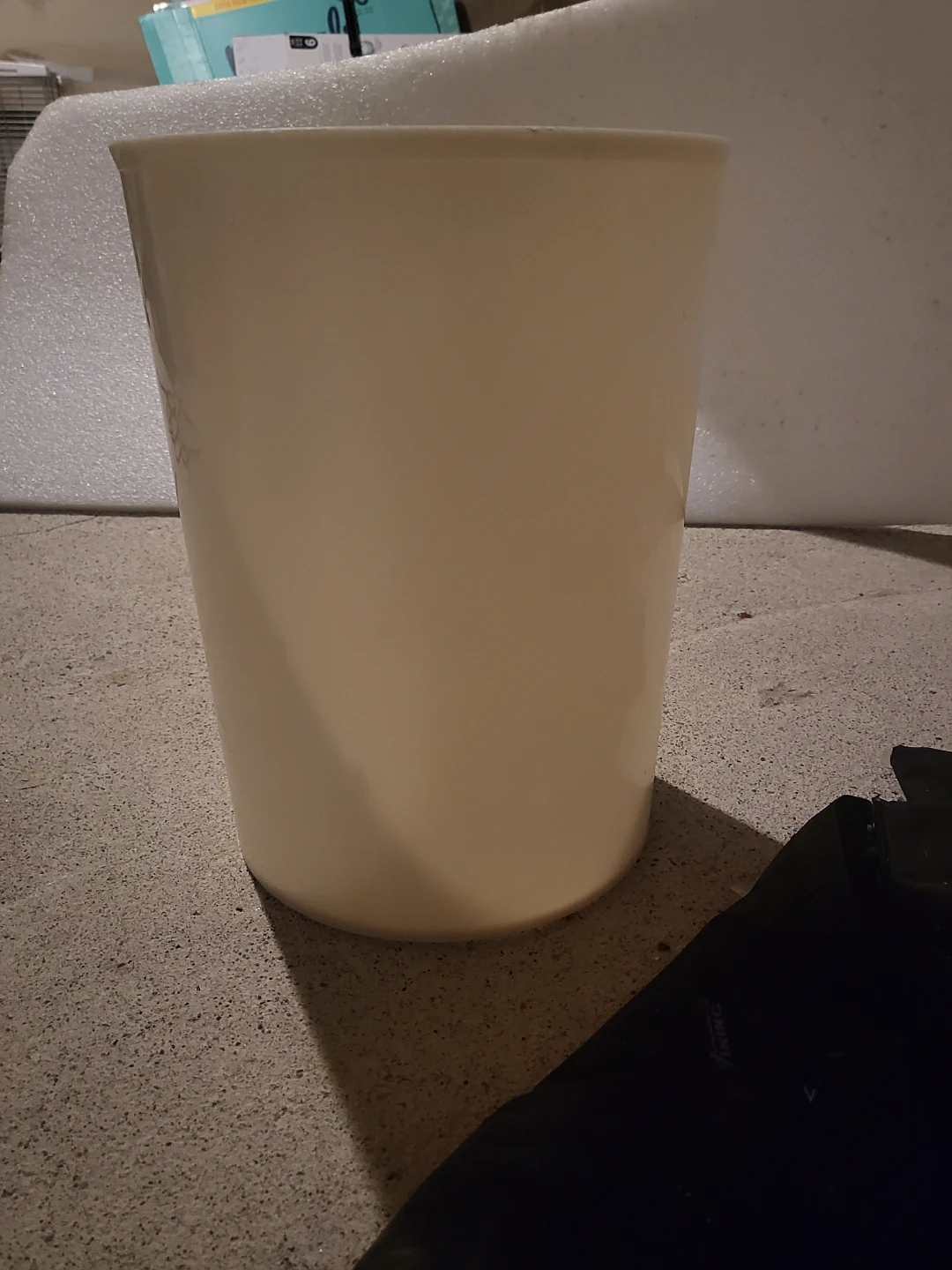 Cream coloured trash can