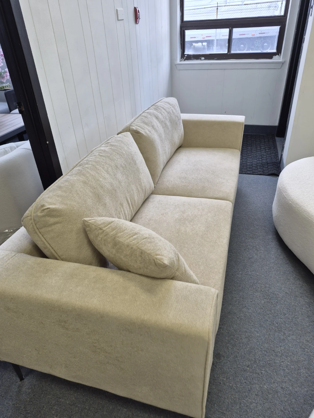 Beige Sofa with Throw Pillow