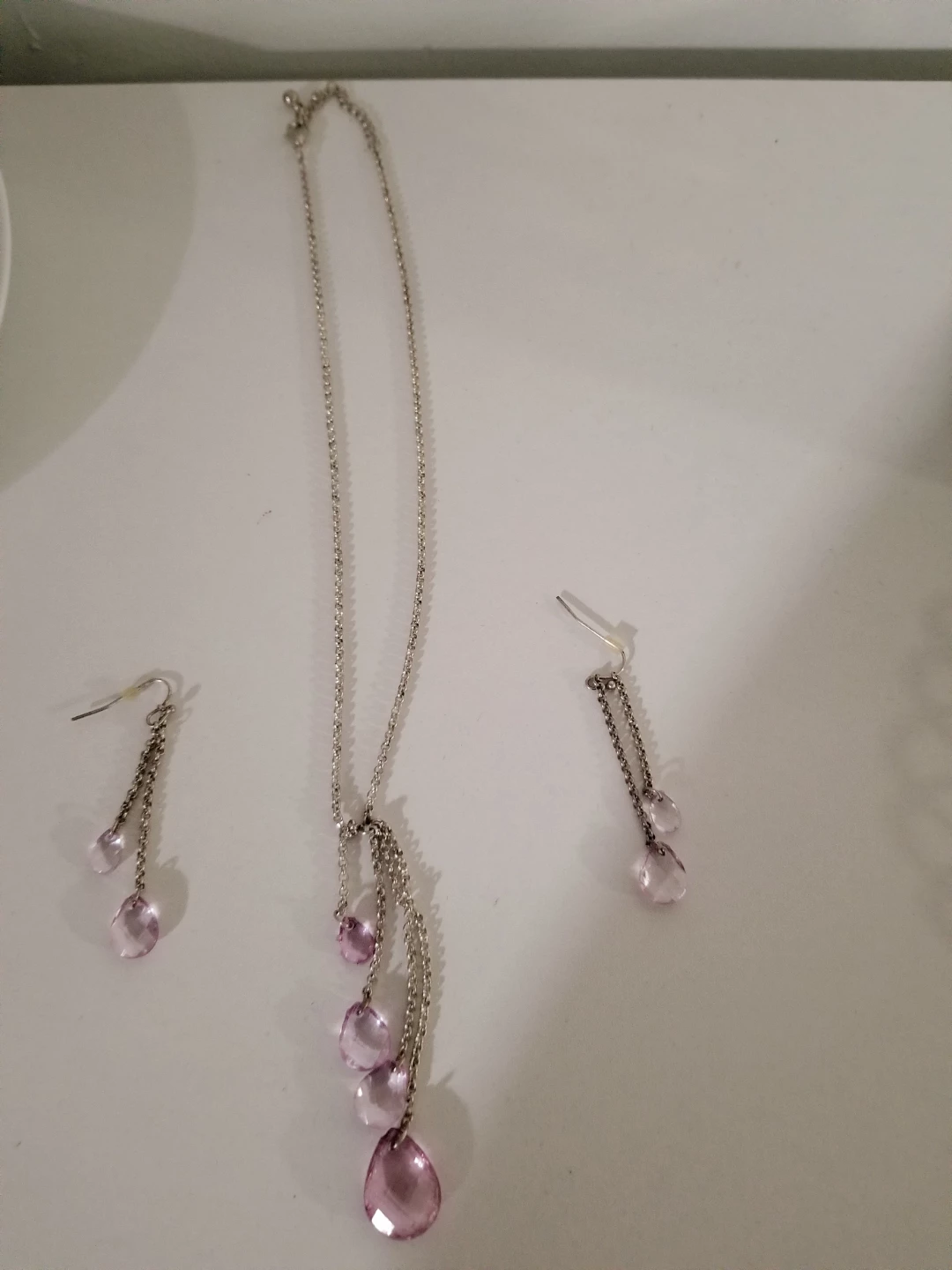 Silver tone necklace and earring set with pink teardrop beads
