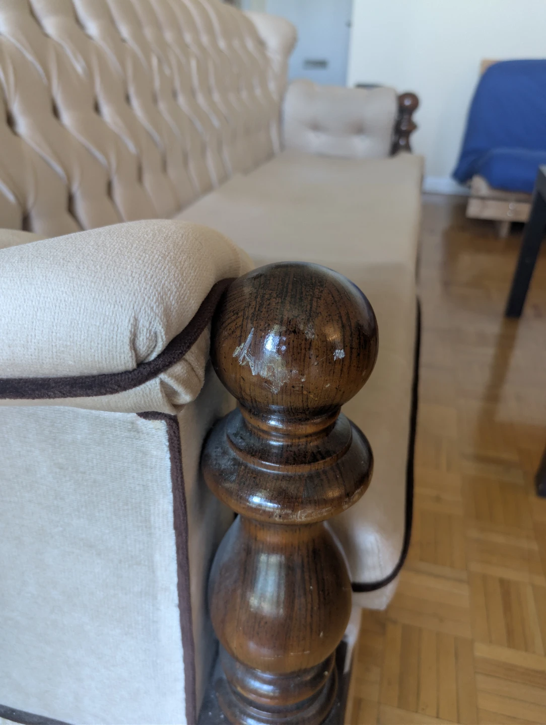 Cream Tufted Sofa with Dark Wood Accents
