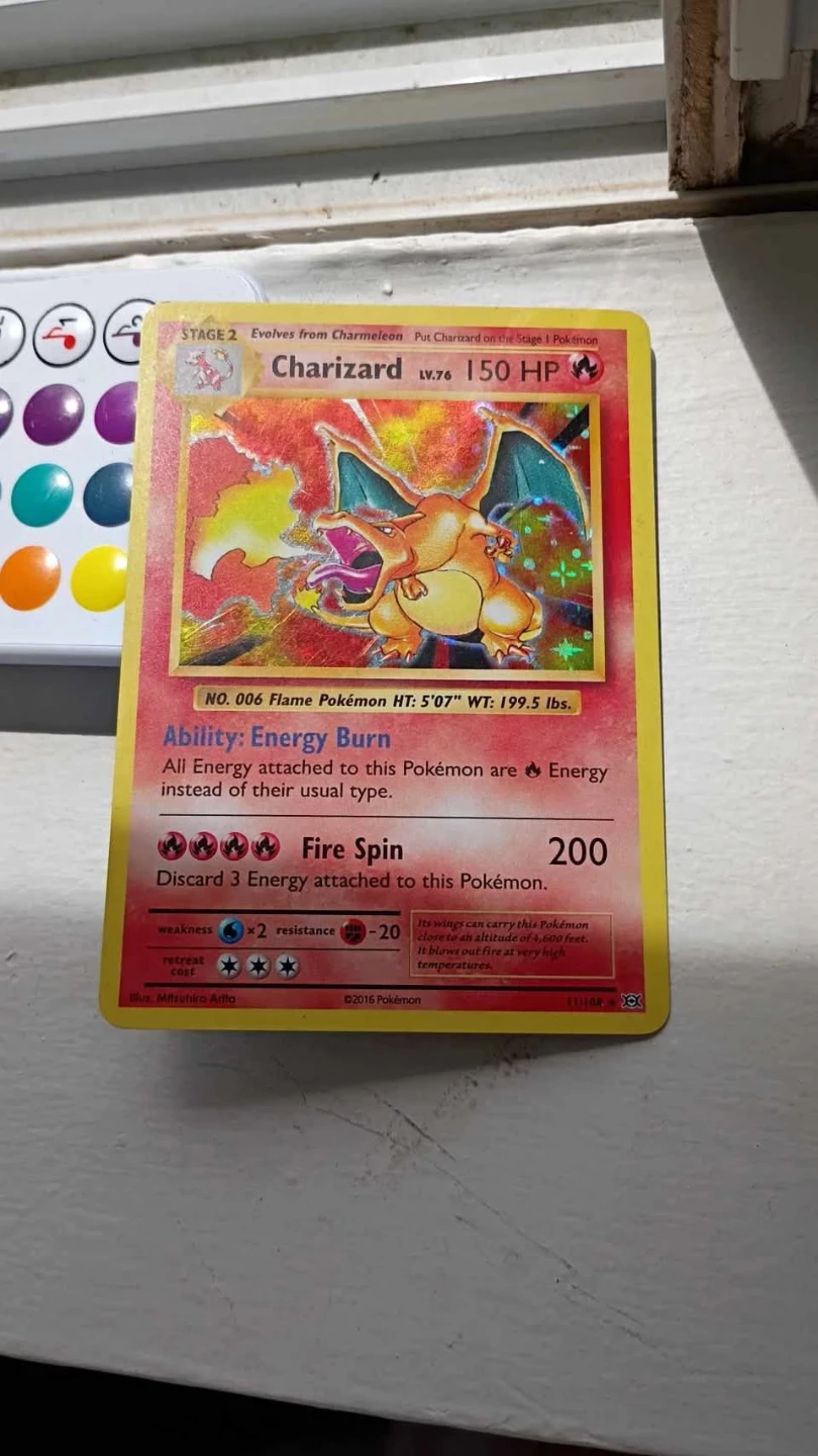 1990 holo charizard card, english text