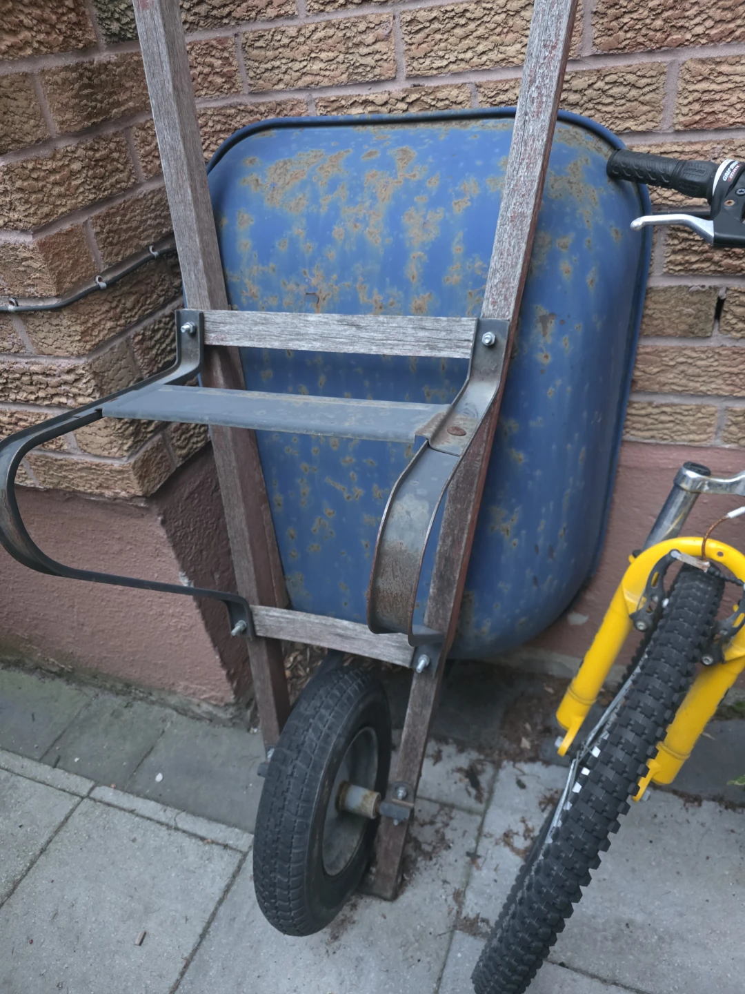 Blue wheelbarrow with wooden handles