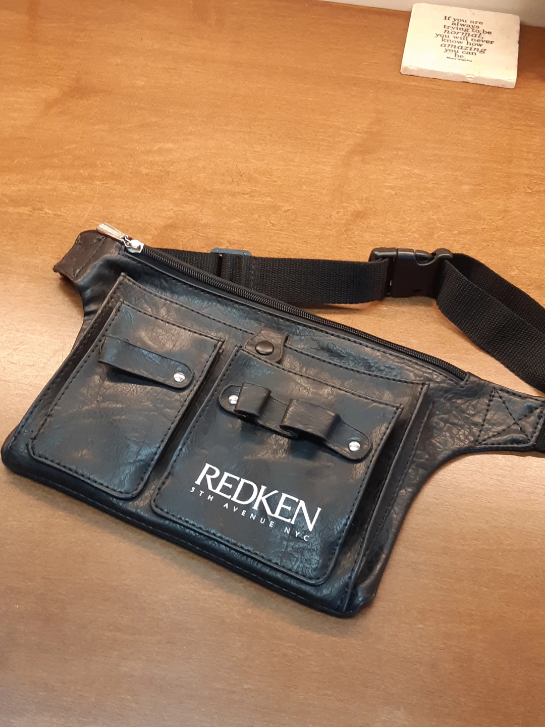 Black Redken hairstylist tool belt