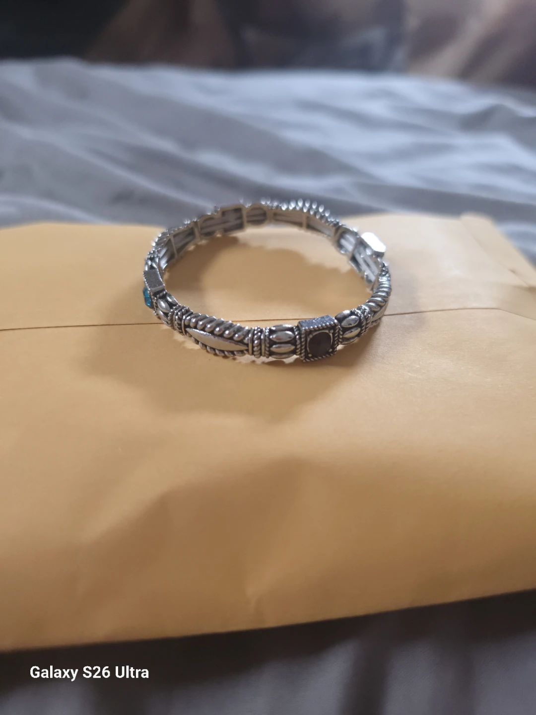 Silver tone stretch bracelet with decorative accents