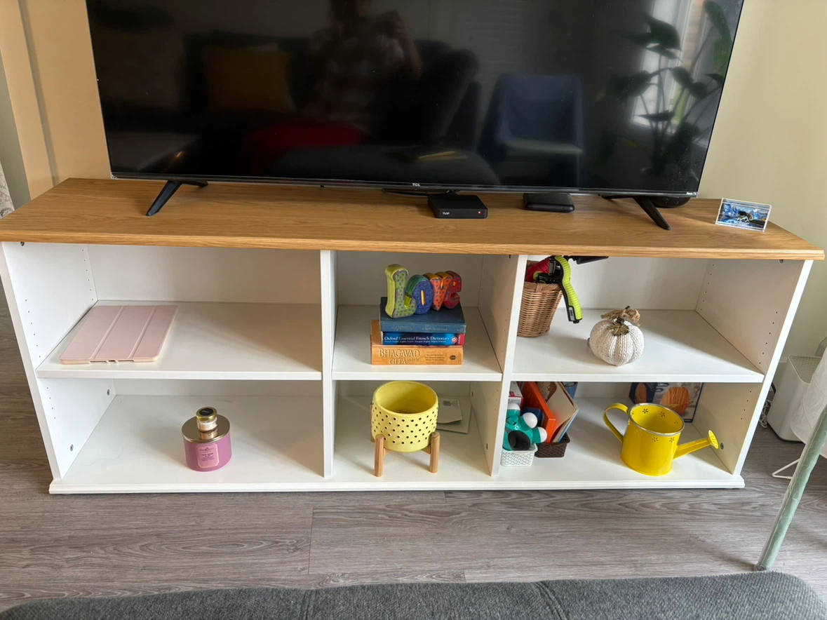 White TV Stand with Wood Top without items placed in the shelf.