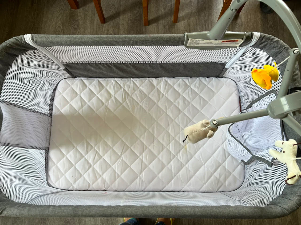 Grey Bassinet with Mobile and Storage Basket