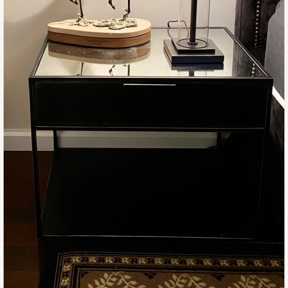 Black metal nightstand with drawer and mirrored top
