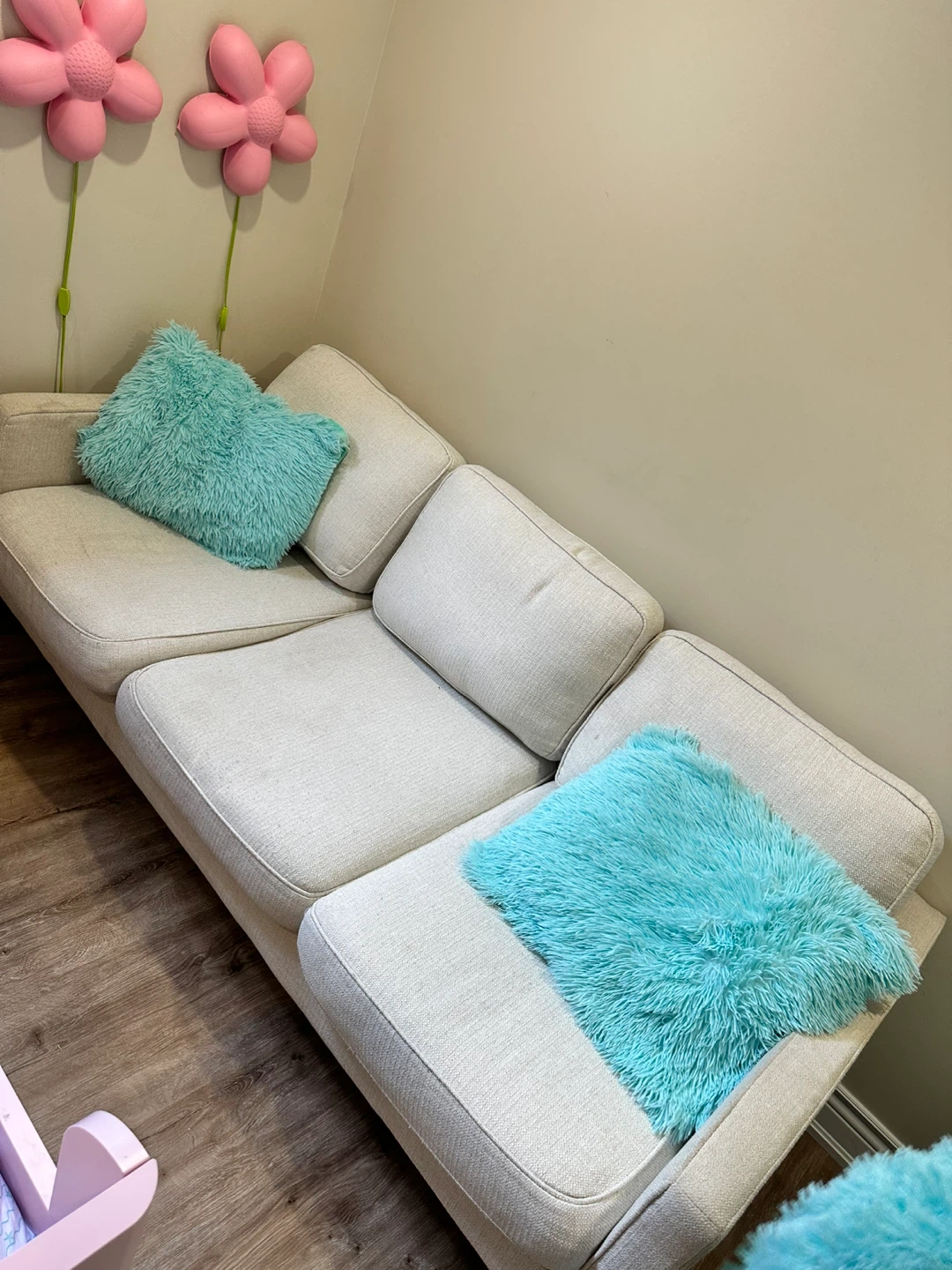 Cream coloured sectional couch with throw pillows