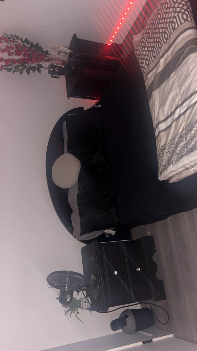 Black nightstand with bed and mattress