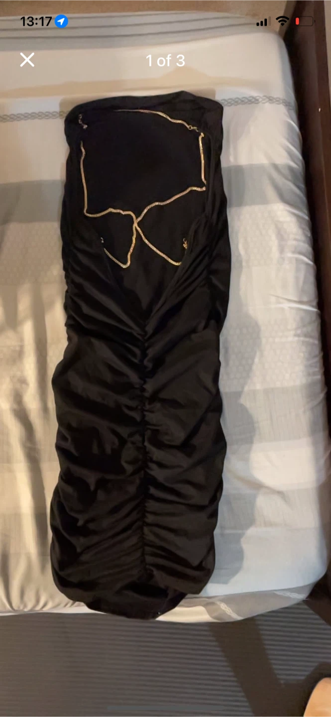 Black ruched strapless dress with gold chain detail