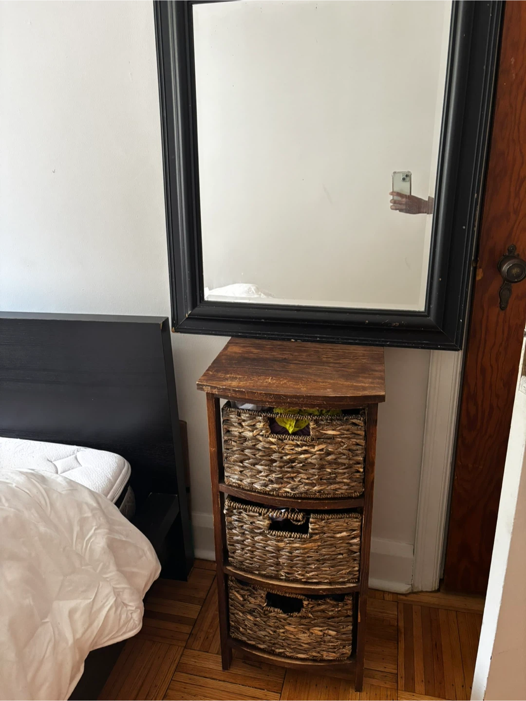 Wooden storage unit with 3 wicker baskets and a mirror