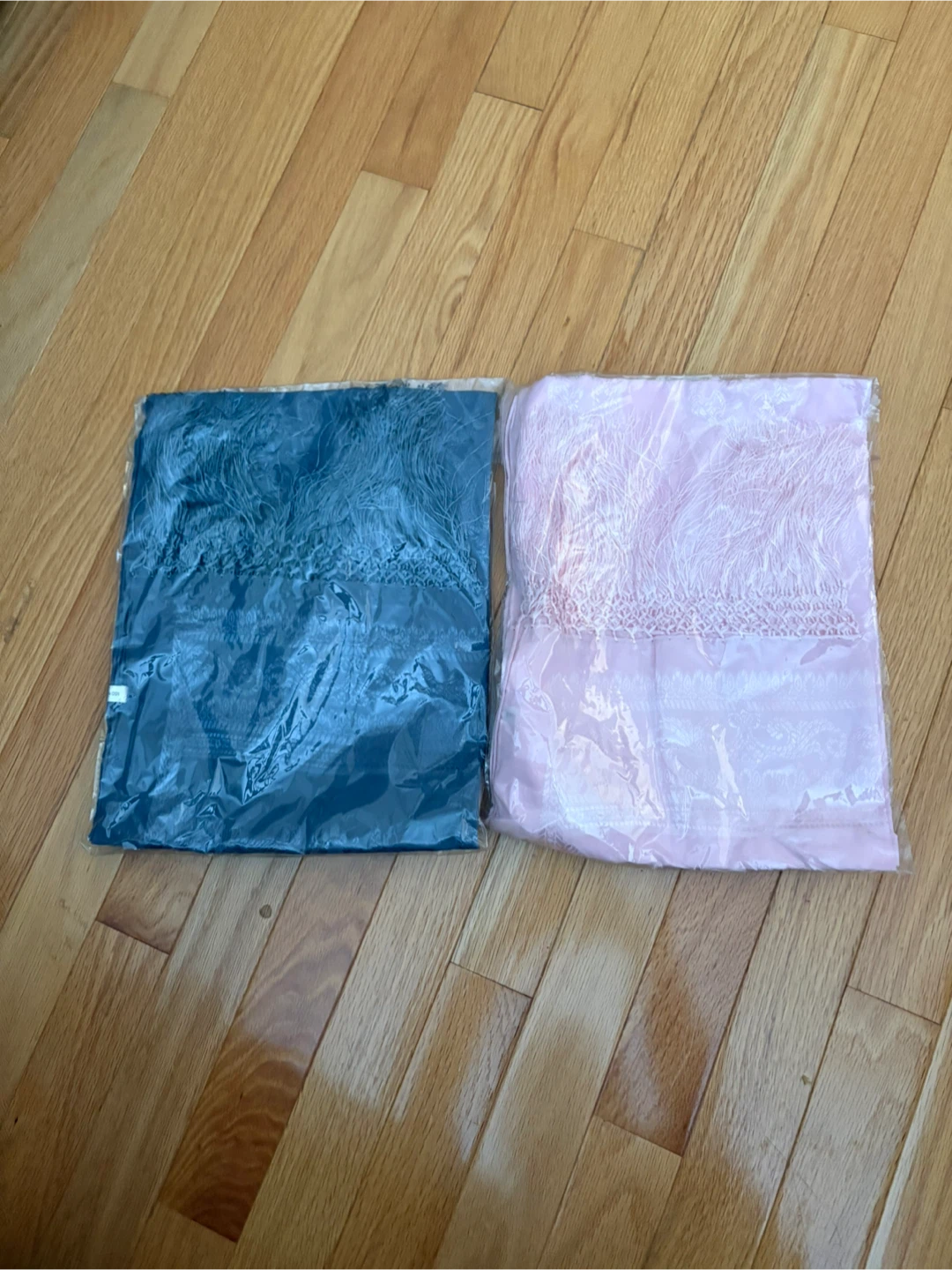 Two decorative scarves, teal and pink