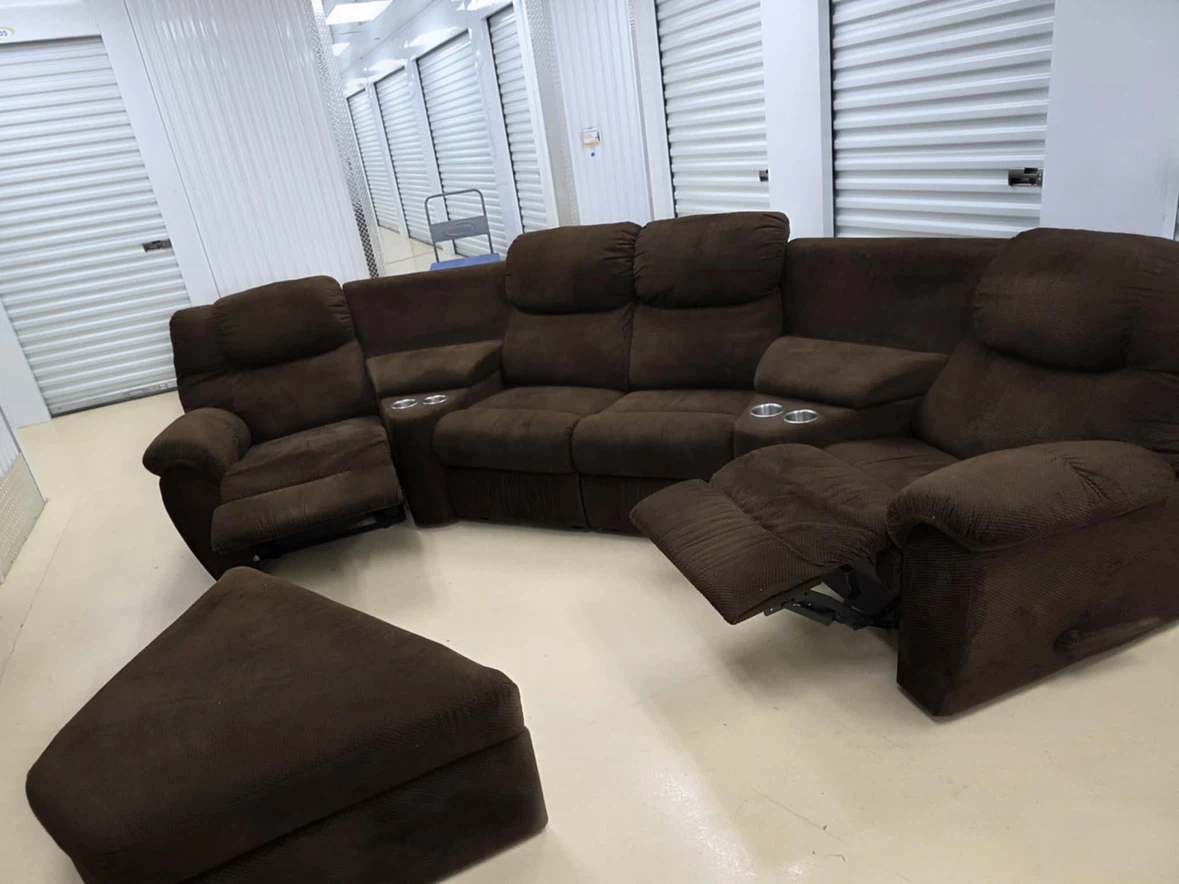 Brown reclining sectional with ottoman and cup holders