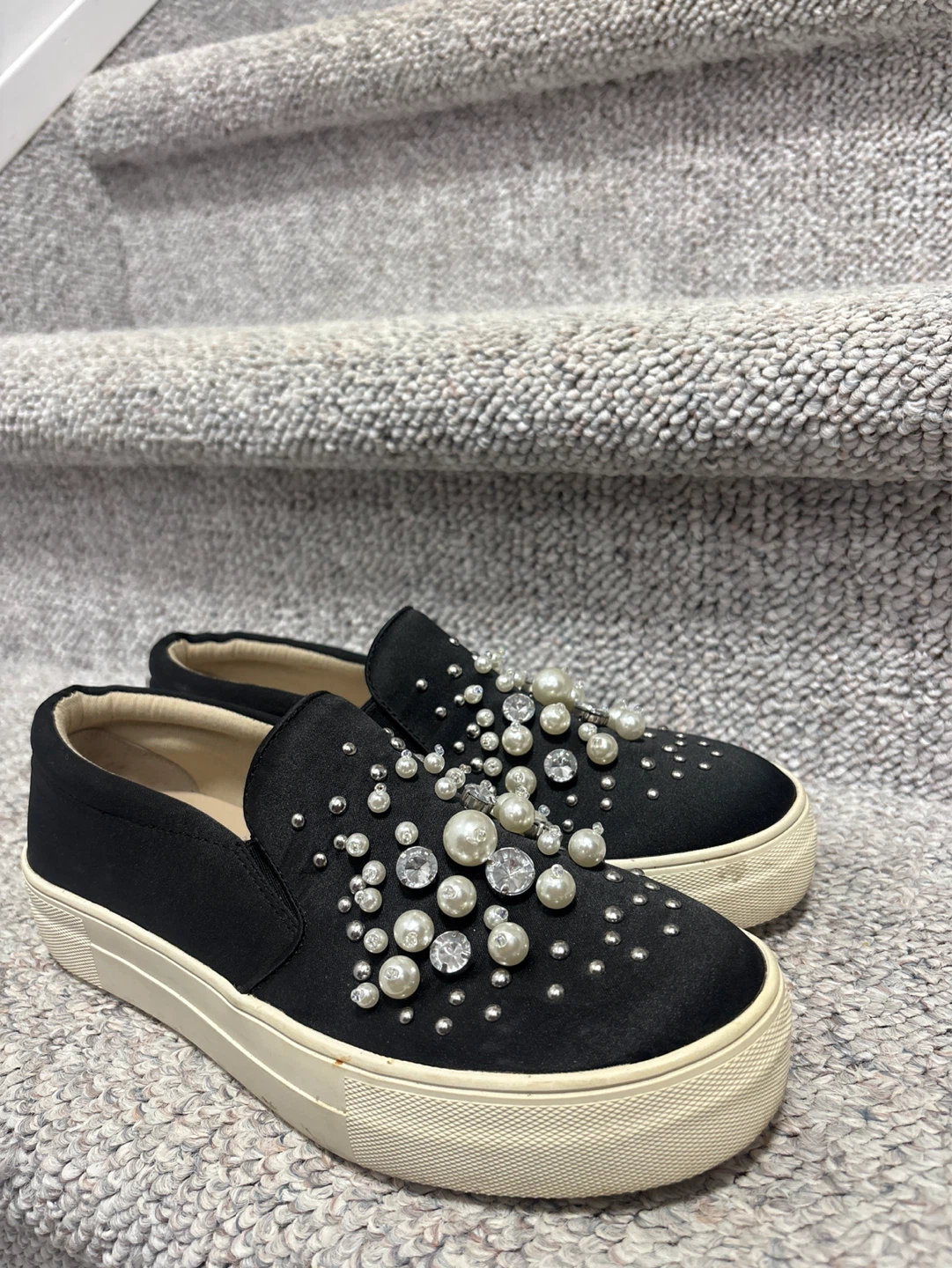 Black slip-on sneakers with pearl and rhinestone embellishments
