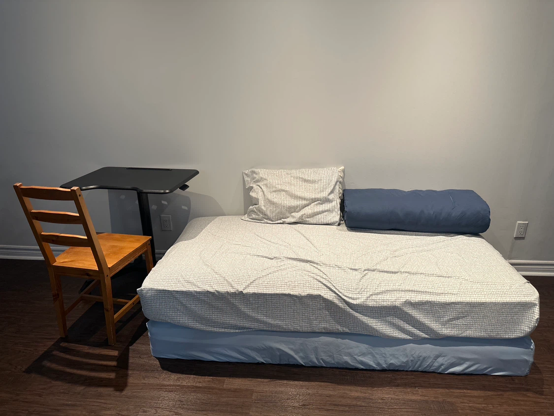 Standing Desk with Wooden Chair, and Single bed with bedding