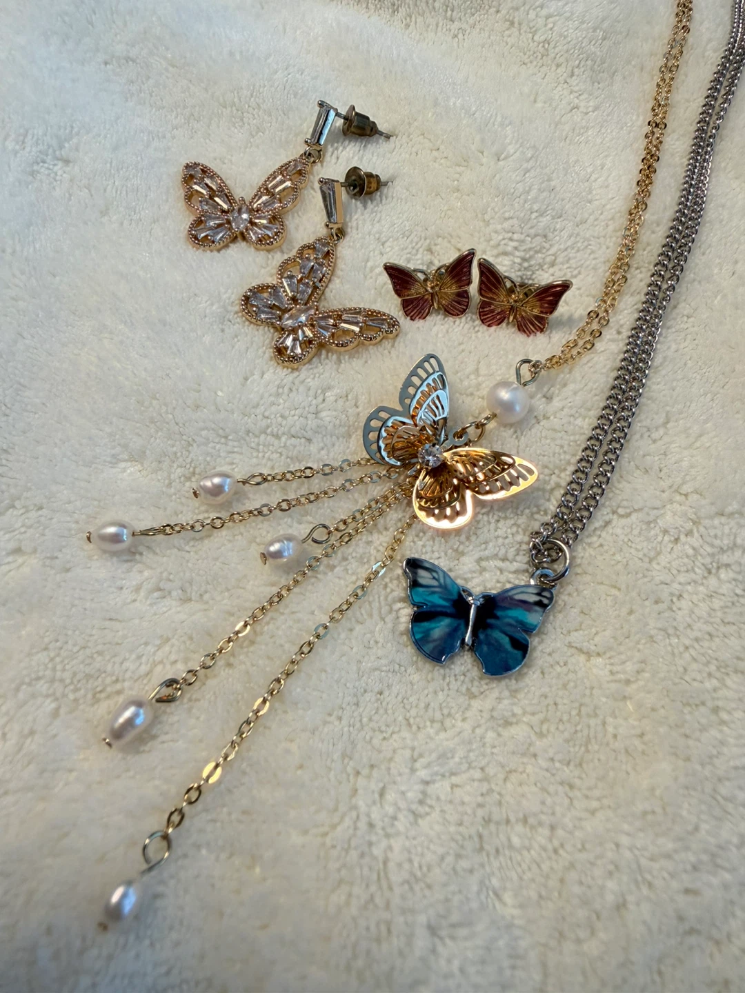 A set of two Butterfly Necklaces and two pairs ofEarrings