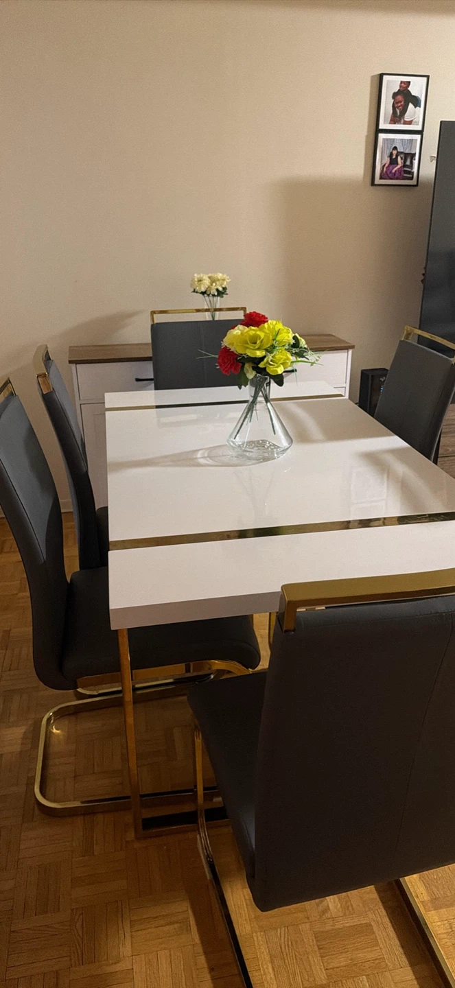 White Dining Table with Gold Accents and Grey Chairs