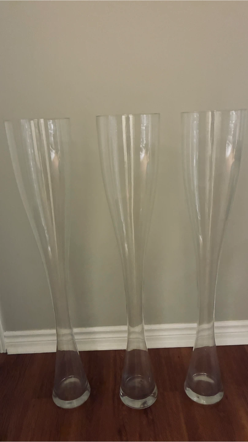 Three 40” high glass vases