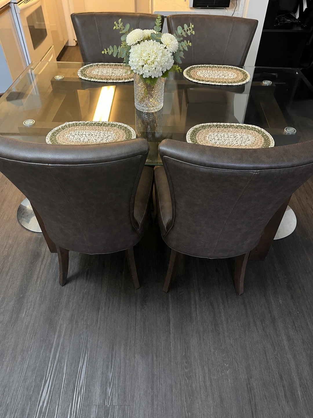 Glass top dining table and leather chairs
