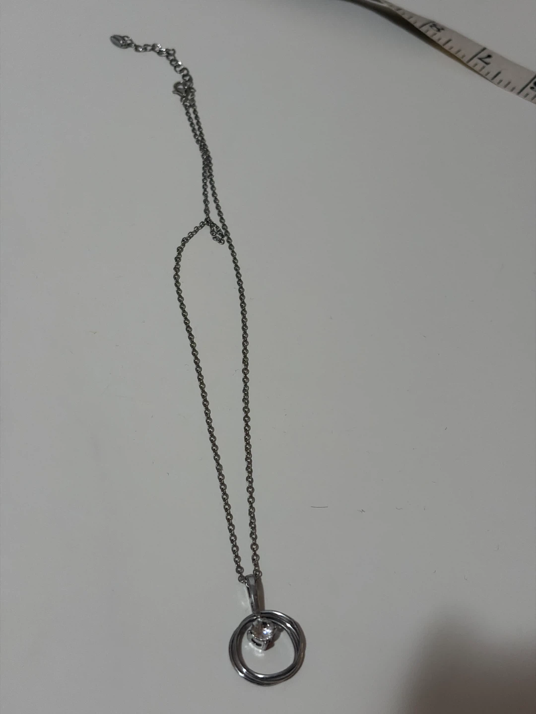 Silver-tone necklace with a sparkling pendant
