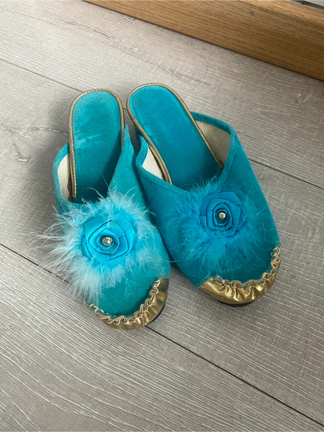 Turquoise slippers with feather and flower detail