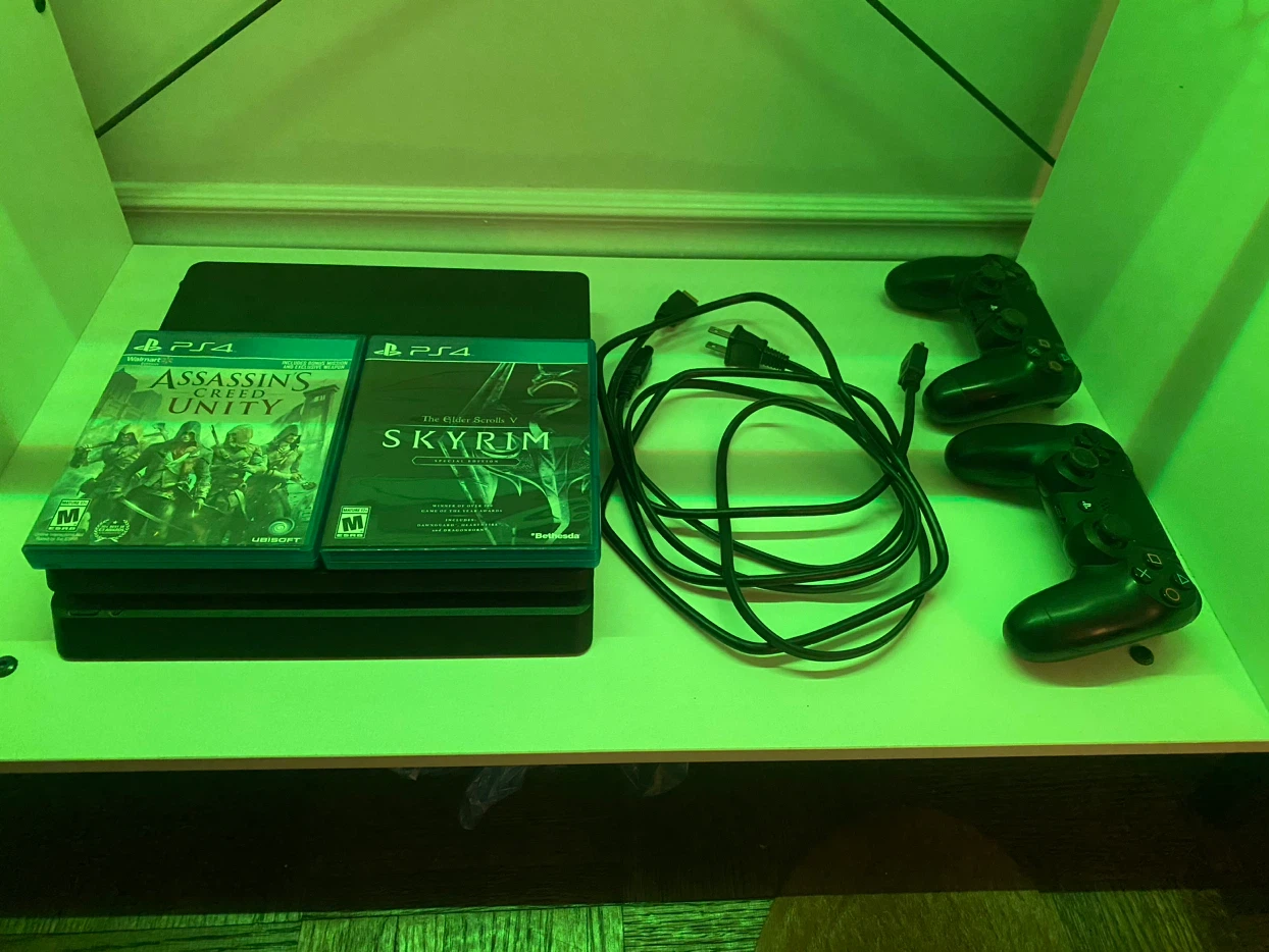 Sony PlayStation 4 Console with Two Games and Controllers