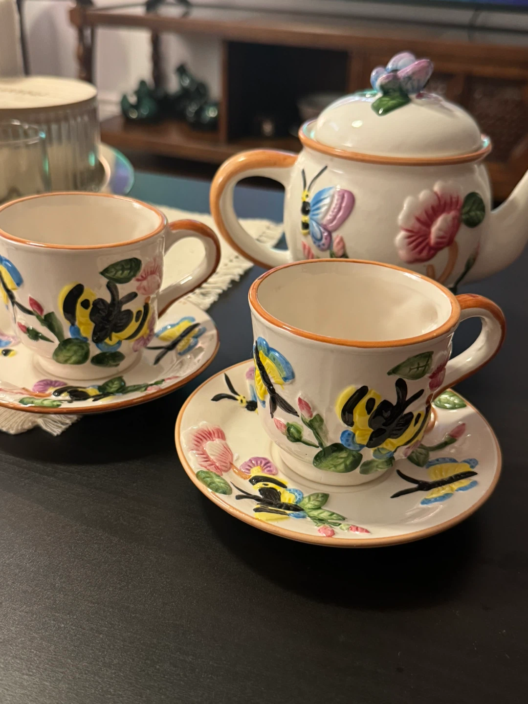 Teapot and cup set with floral and butterfly design
