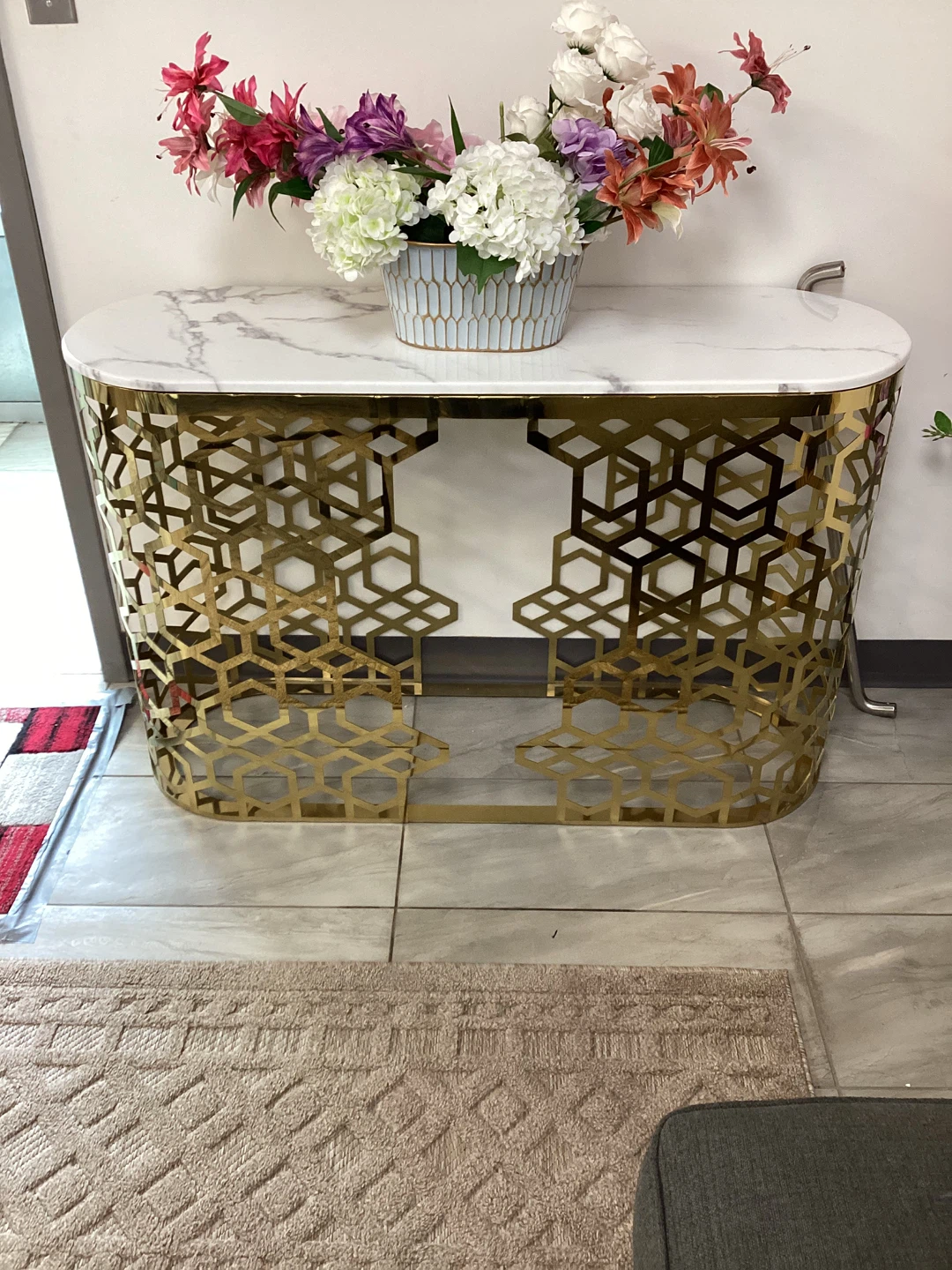 Marble top console table with gold geometric base