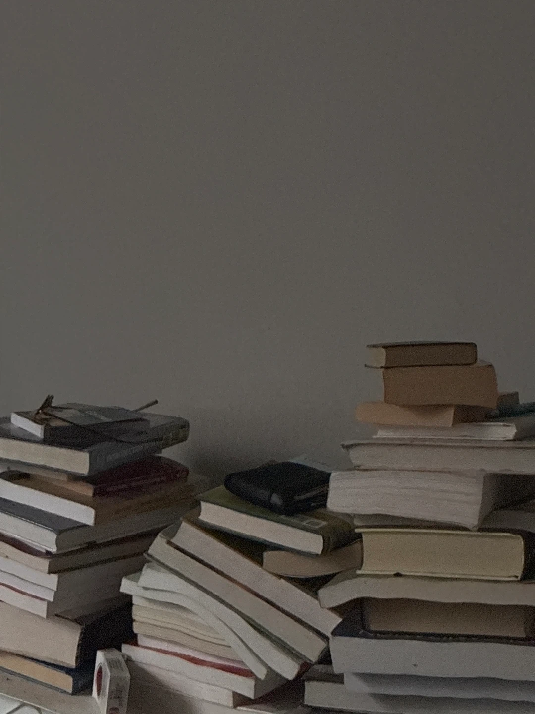 Assorted stack of paperback books