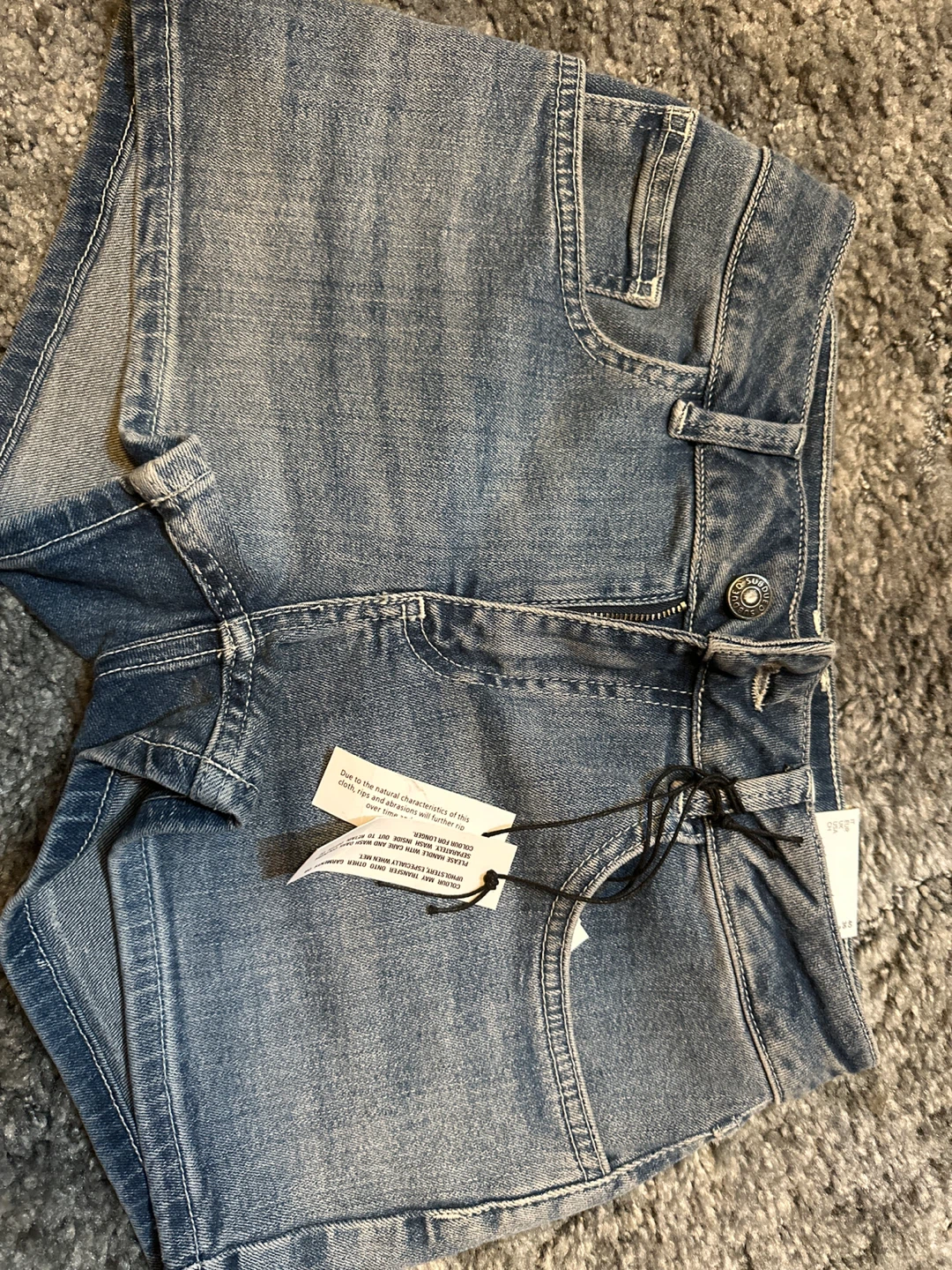 Subdued Denim Shorts with hibiscus design on back pockets