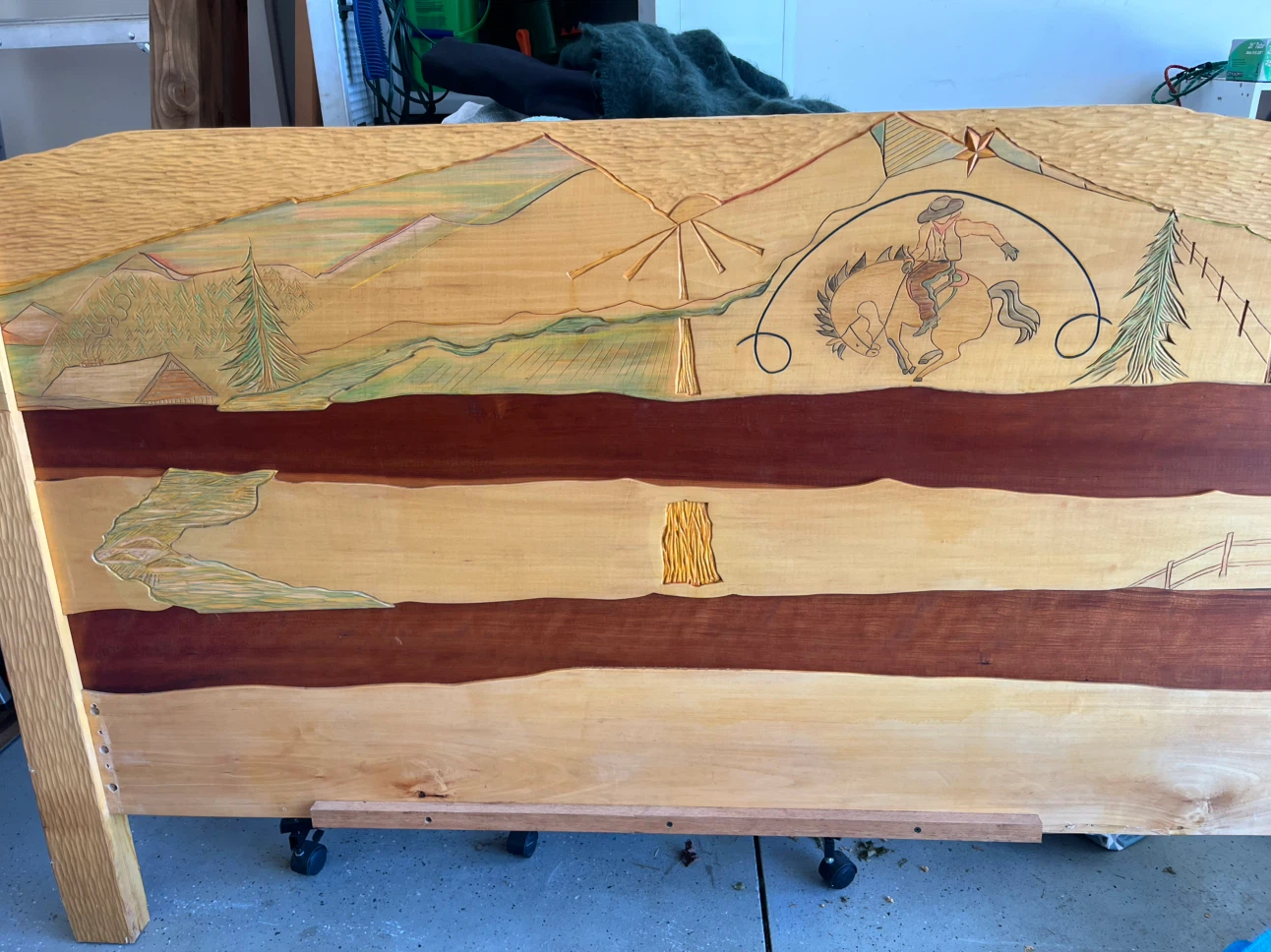 Hand-carved wooden headboard with Western theme
