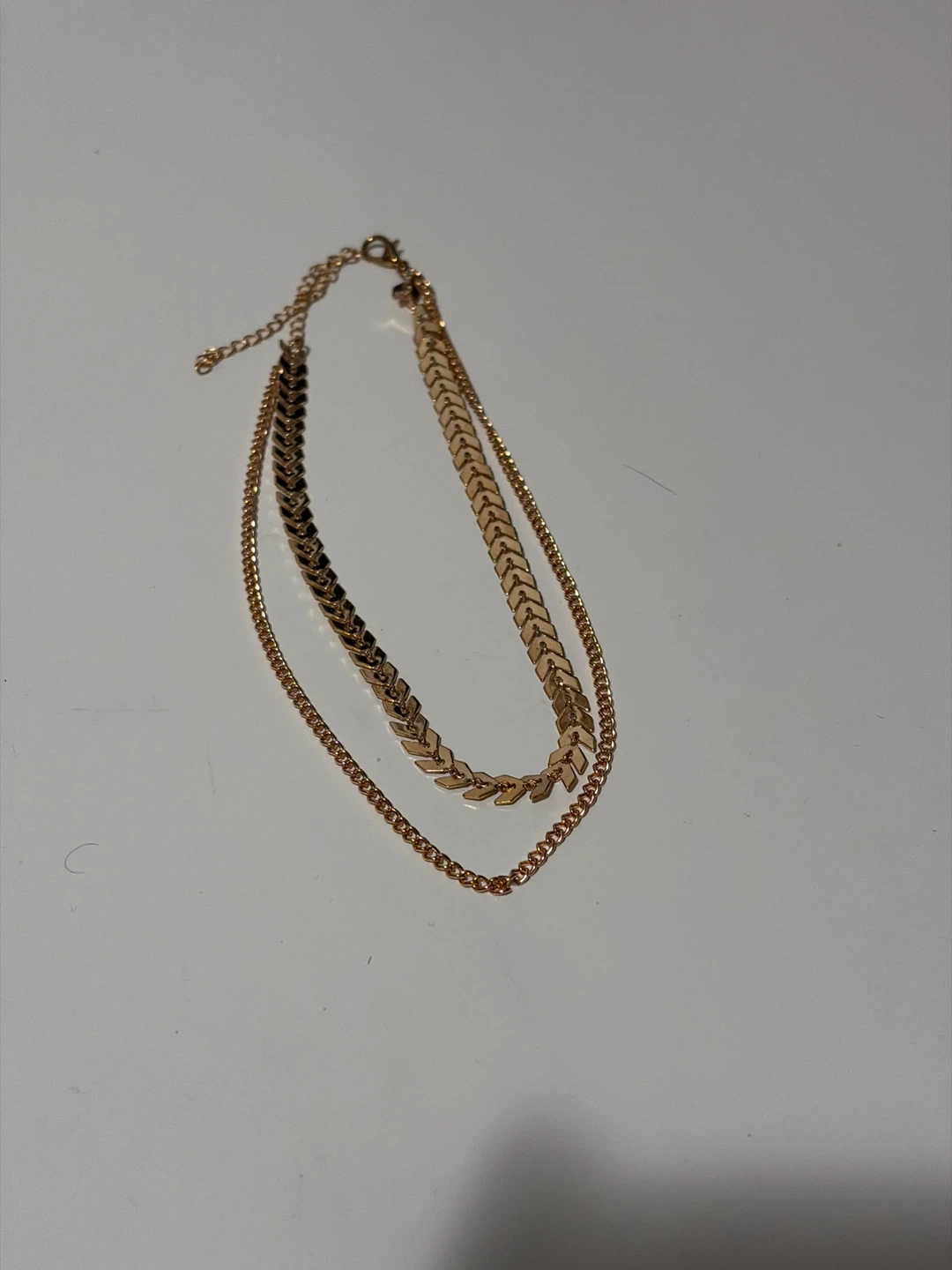 Gold-tone layered necklace with chevron design