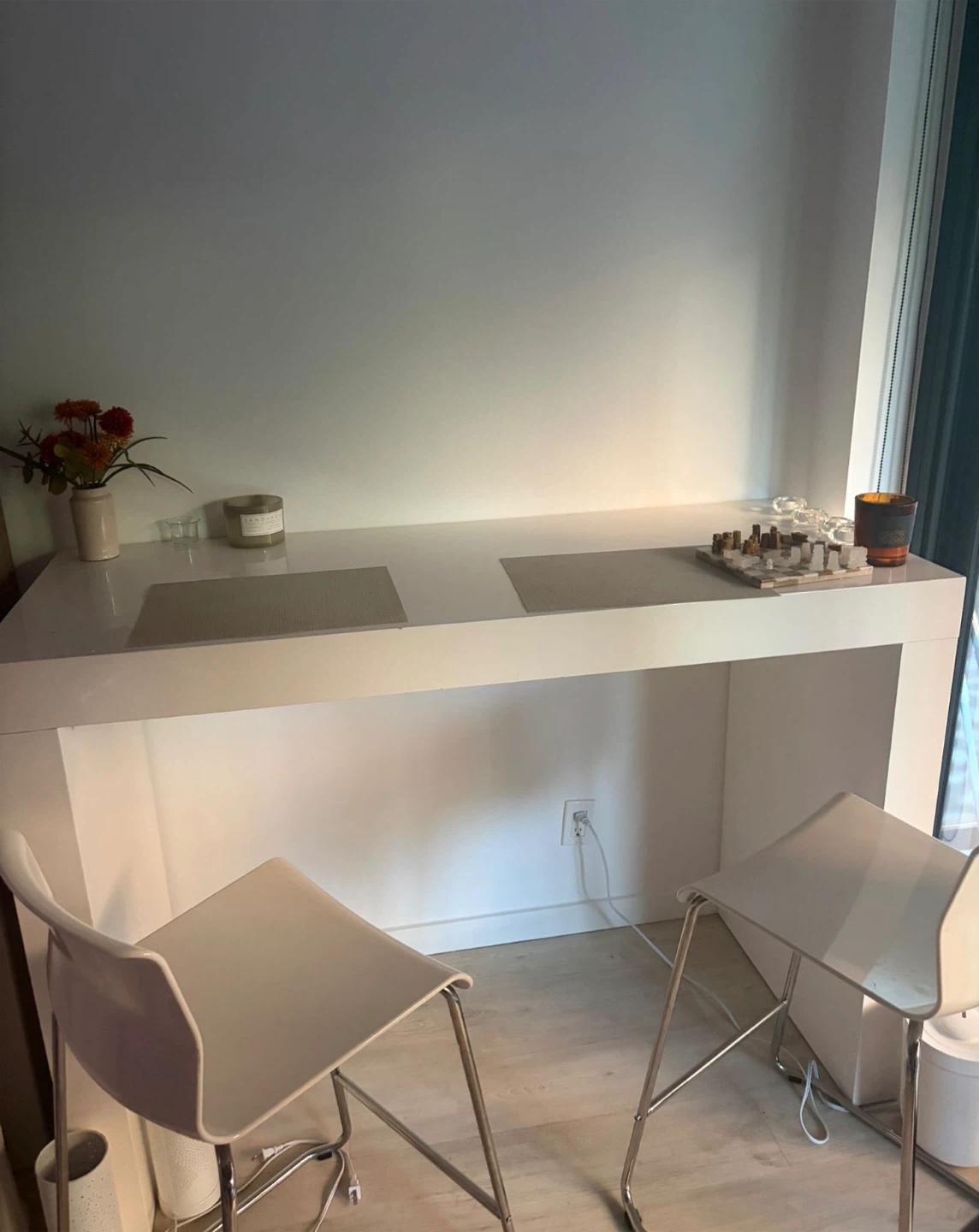 White bar counter with two stools