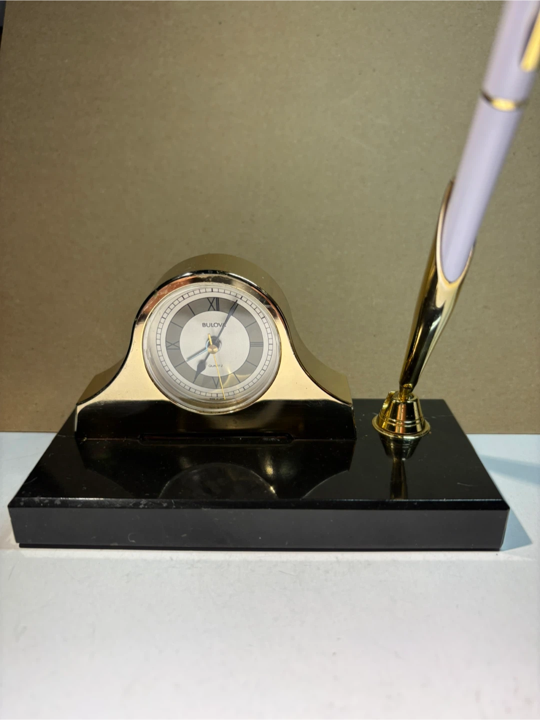 Vintage Bulova Quartz Clock with Pen Holder on marble base.