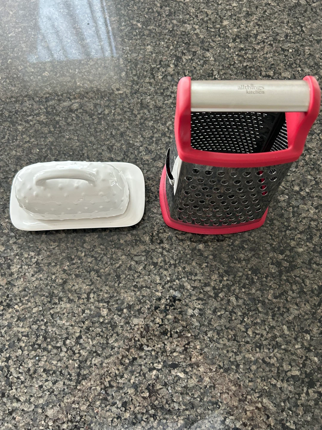Metal box grater and ceramic butter dish